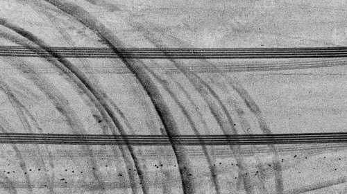 Preview: Aerial view tire track mark on asphalt tarmac road race track texture and background.