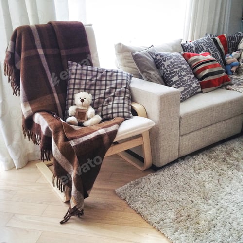 Cozy Chair with a Plaid Blanket and Pillow