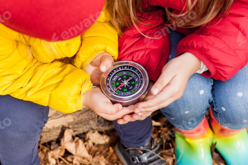 Preview: Girls Toddler holding compass in the hands.