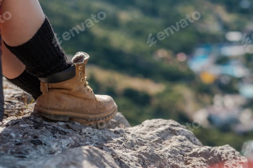 Preview: Young woman sitting on cliff and enjoy the view
