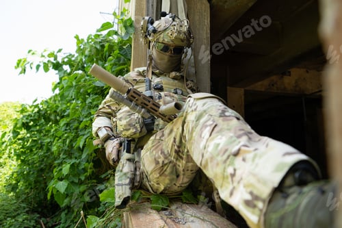 Preview: A gun, the personal weapon of a special forces soldier in camouflage,