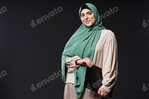 Preview: Woman Wearing Hijab with Laptop on Dark Background