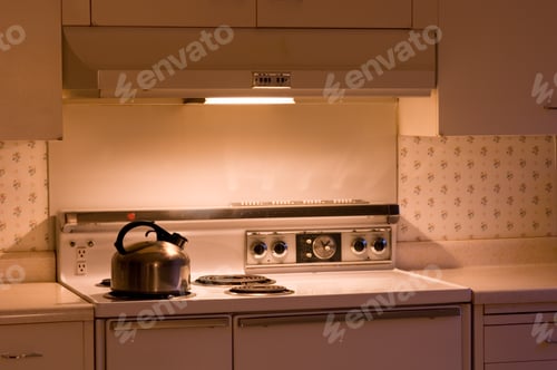 Preview: Gas stove with a pot on it in the kitchen surrounded by cupboards under the lights