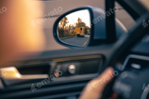 Preview: The view of the road in the car's rearview mirror.