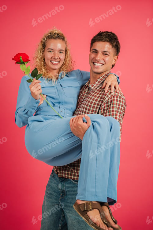 Preview: couple sharing a romantic moment while carrying each other with a beautiful red rose bouquet in hand