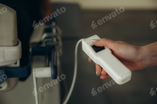 Preview: Hand using medical equipment remote control button