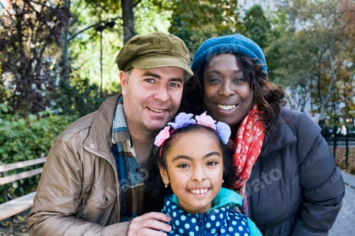 Preview: Family in park looking at camera smiling