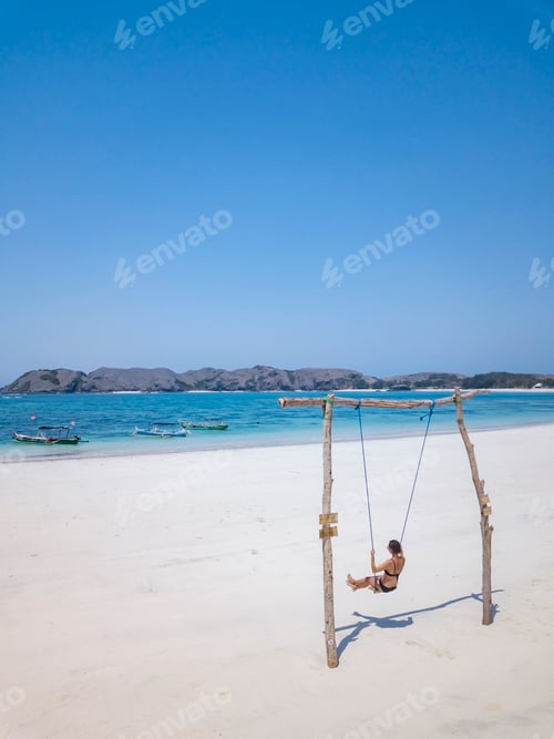 Preview: Indonesia, Lombok, young woman on a swing