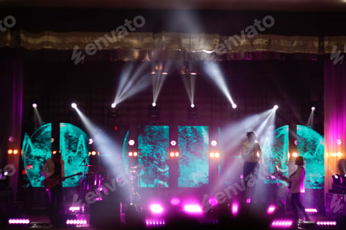 Preview: music band on the stage. Bands silhouettes on a concert. Guitarist on stage for background, soft foc