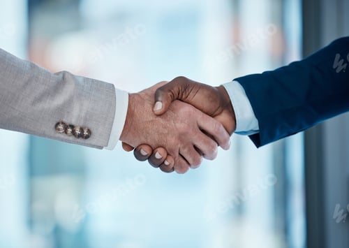 Preview: Open more doors, close more deals. Shot of two businessmen shaking hands in a modern office.