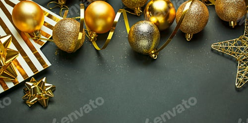 Preview: Christmas gold balls and decorations on a dark background. New Year decor. Copy space.