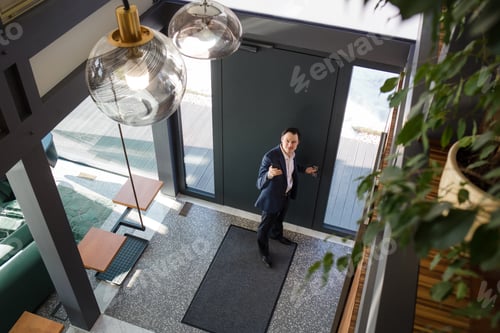 Preview: Man controlling home light with digital tablet in his house.