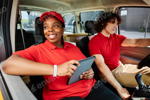 Preview: Smiling Delivery Worker Using Tablet in Vehicle