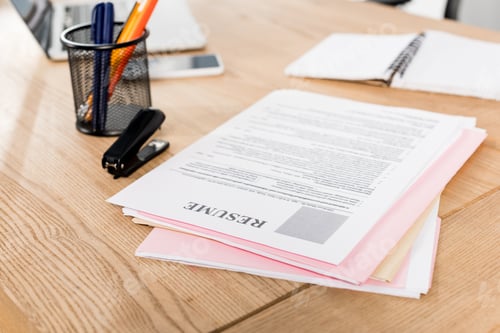Preview: selective focus of resume near stapler and pen holder on table