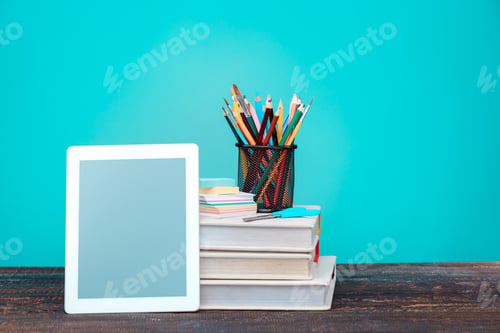Preview: Back to School concept. Books, colored pencils and laptop