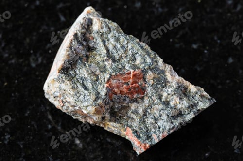 Preview: sample of raw gneissoid granite rock on black