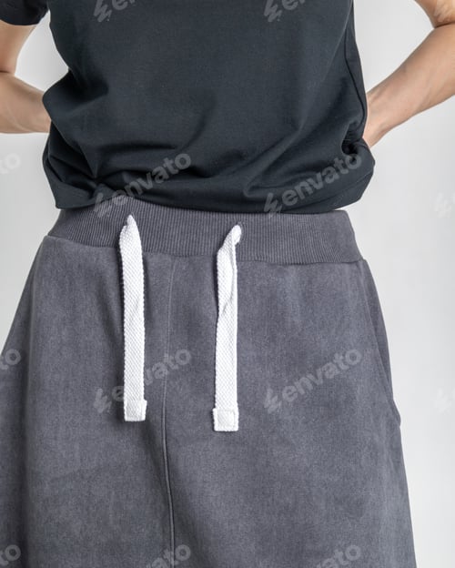 Preview: Close-up black clothes on woman on light background. Vertical photo