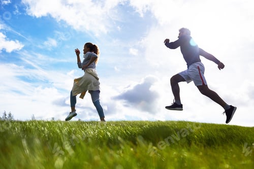 Preview: Active Man and Woman Running on Green Hillside