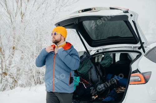 Preview: Man preparing for winter solo hike in snowy nature