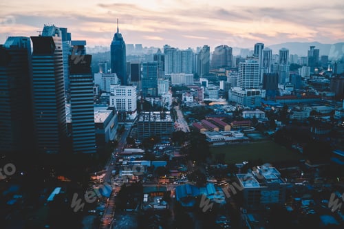 Preview: Modern megapolis with geometric architecture buildings at sunset
