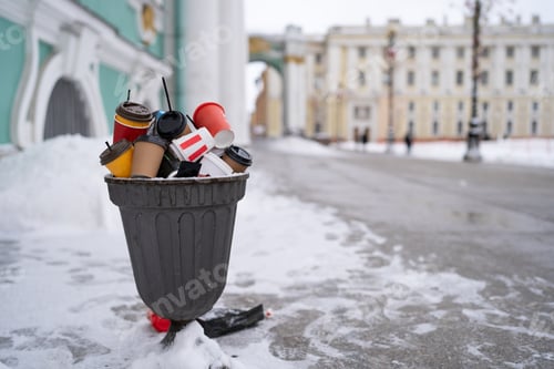 Preview: Overcrowded trash basket on the street in winter time. Pile of disposable plastic and paper cups.