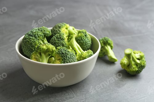Preview: Bowl and fresh broccoli on grey table. Space for text