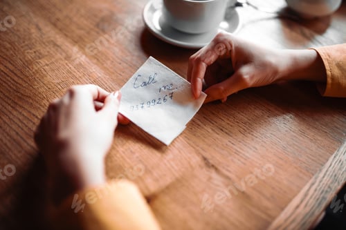 Preview: Female person hands holds love note