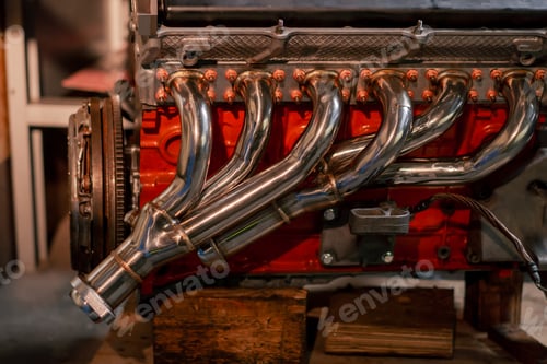 Preview: close-up at service station metal exhaust system several pipes converge into one down