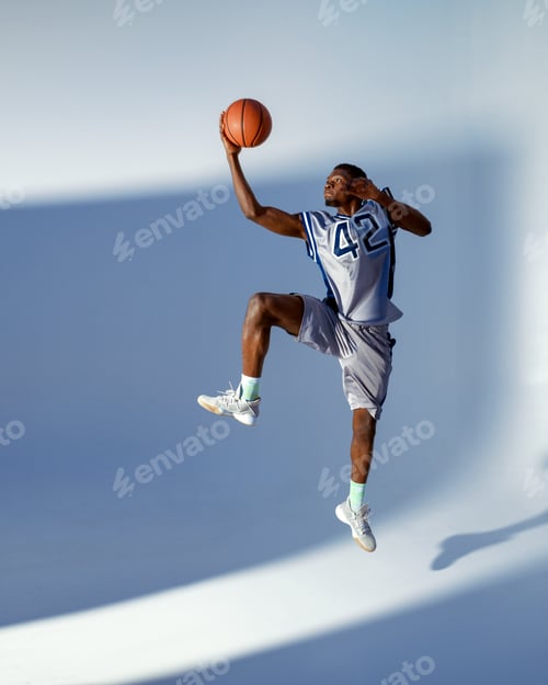 Preview: Basketball player with ball, high jump in action