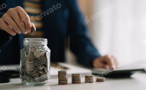 Preview: Person Adds Coins to Jar Beside Calculator