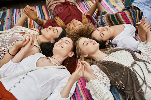 Preview: joyful multiethnic women with closed eyes holding hands, blanket, outdoors, retreat center