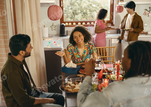 Preview: Happy friends enjoying in conversation and drinking wine during festive dinner at home party