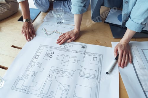 Preview: Close up hands of professional design engineers working with project documents in modern office