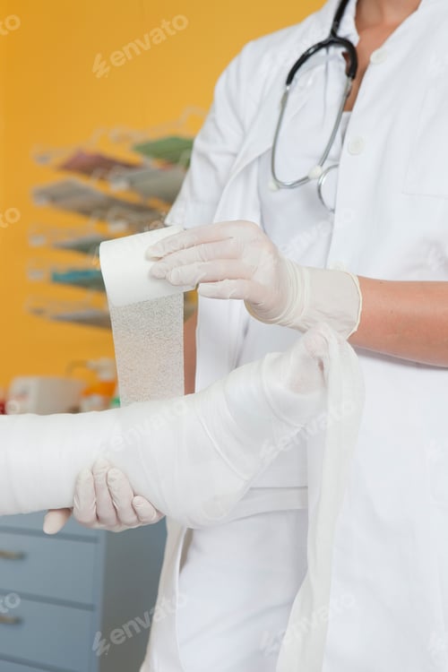 Preview: Close up of hands applying a dressing
