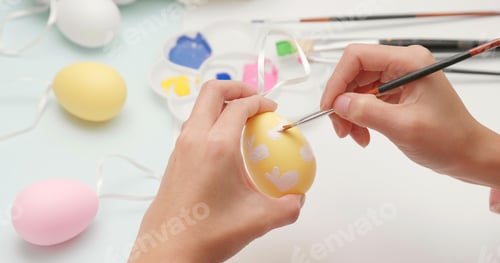 Preview: Painting colorful egg for Easter holiday at home