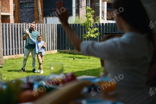 Preview: Dad and son play on the lawn near the house