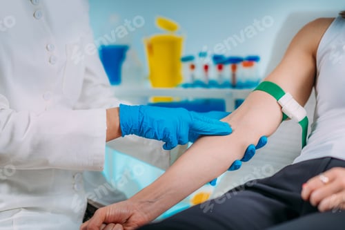 Preview: Preparation for phlebotomy procedure, female patient and medical nurse wearing protective masks