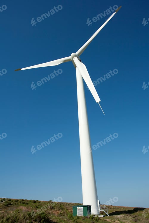Preview: Low angle of a windmill turbine against a blue sky