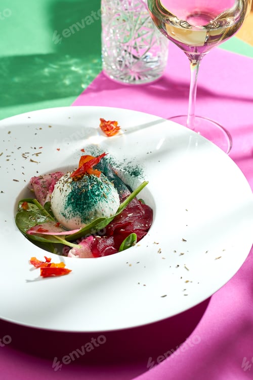 Preview: Poached egg with pear confit in a white plate. Colored backgrounds. Hard light. selective focus