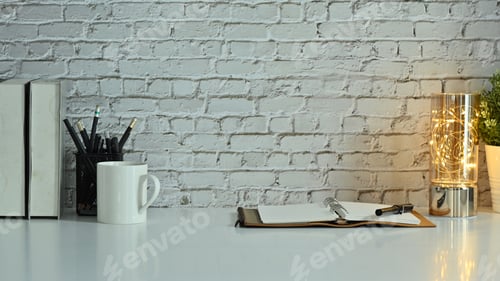 Preview: Stylish workplace with opened notebook, pencil holder, coffee cup and books on white table