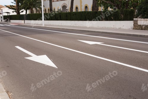 Preview: Arrow signs as road markings on a street with two lanes