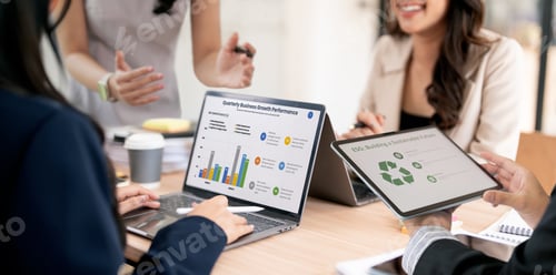 Preview: Business team analyzing growth on a laptop and discussing sustainable ESG goals during a meeting.