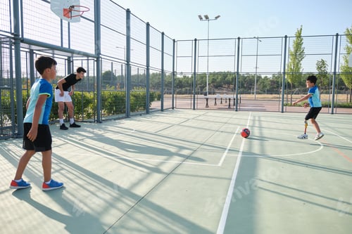 Preview: Three brothers playing football, one of them has a leg prosthesis and is kicking a penalty