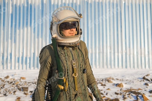 Preview: Pilot Astronaut Is On A Snow-Capped Top. Astronaut In A Protective Suit And Helmet.