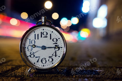 Preview: Retro alarm clock with vintage efect at night on the street