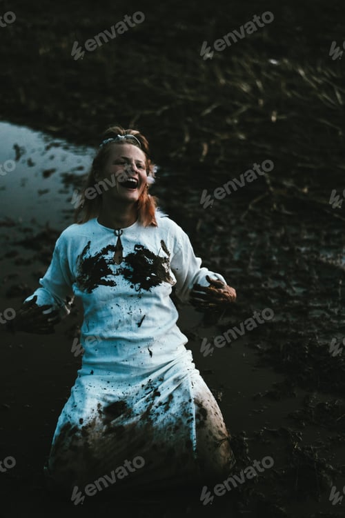 Preview: Happy woman with dirty black hands on a muddy field, joyful emotions in monochrome