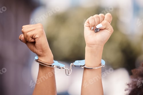 Preview: Activist woman hands fist, handcuffs and social justice protest of women protesting outdoor. Hand v