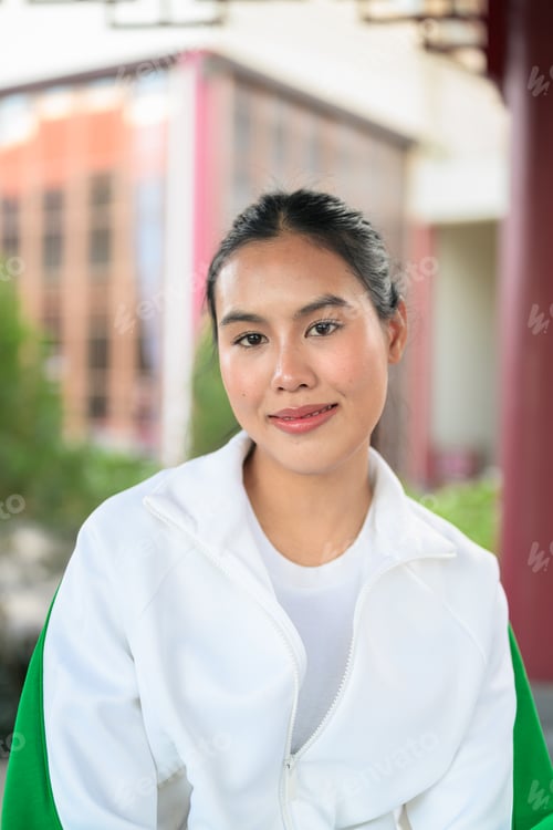 Preview: Young Asian Woman in Sporty Casual Outfit Outdoors in Zen Garden