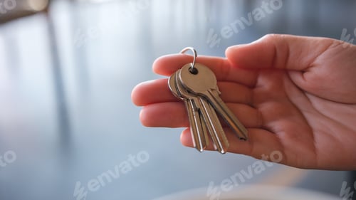 Preview: Closeup image of a hand holding the keys for real estate concept