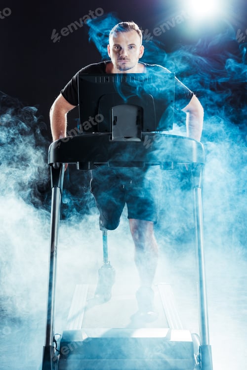 Preview: young caucasian paralympic sportsman exercising on treadmill